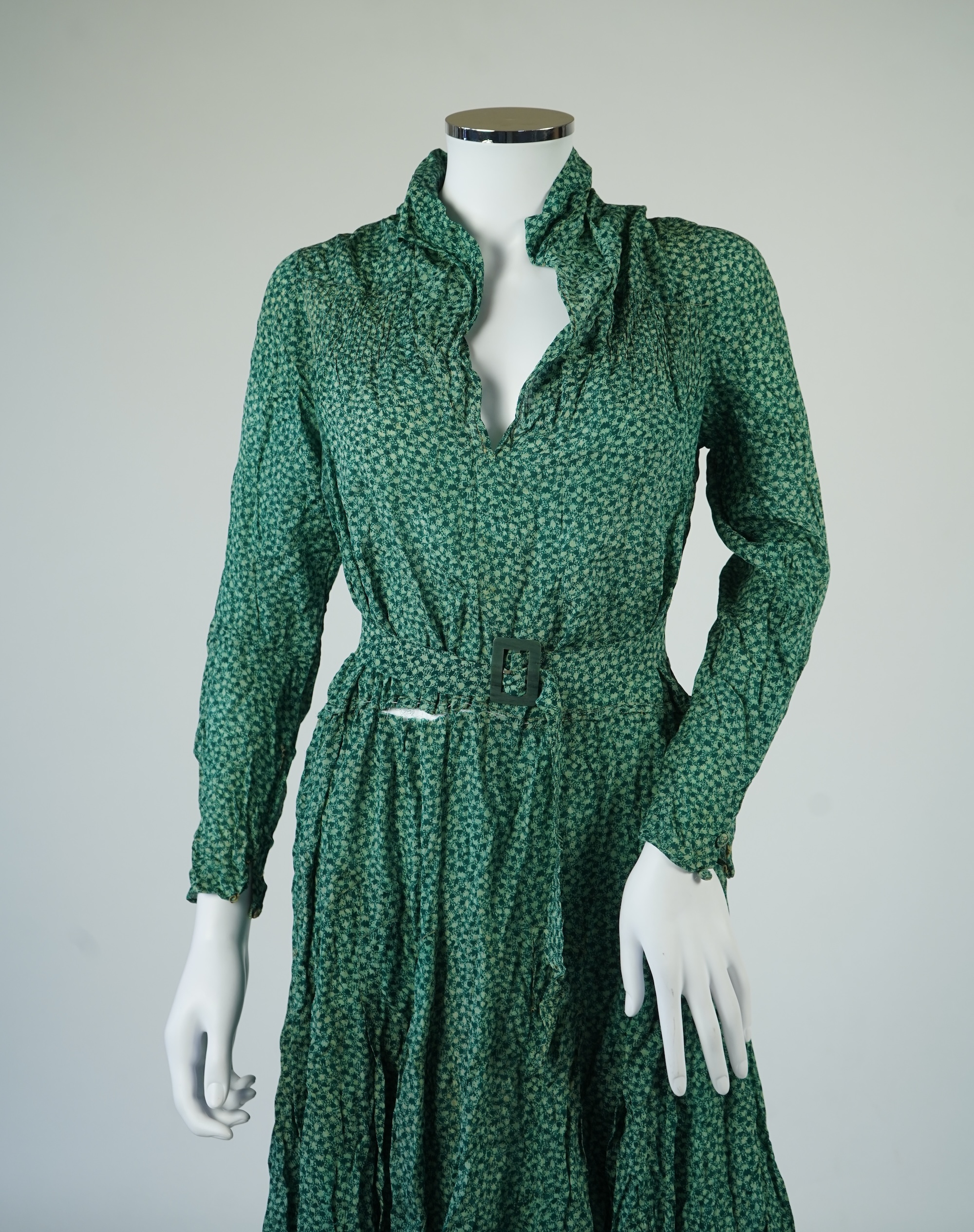 Two 1930's printed silk crepe summer day dresses together with a similar pale blue and black stripped summer day dress., Condition - the maroon and cream dress has damage to one sleeve, the green dress has worn under the